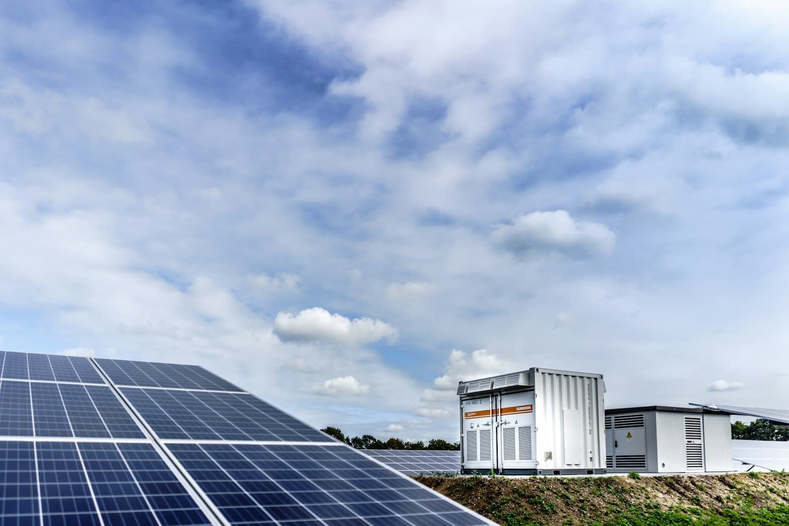 Solar panels with inverter stations behind them