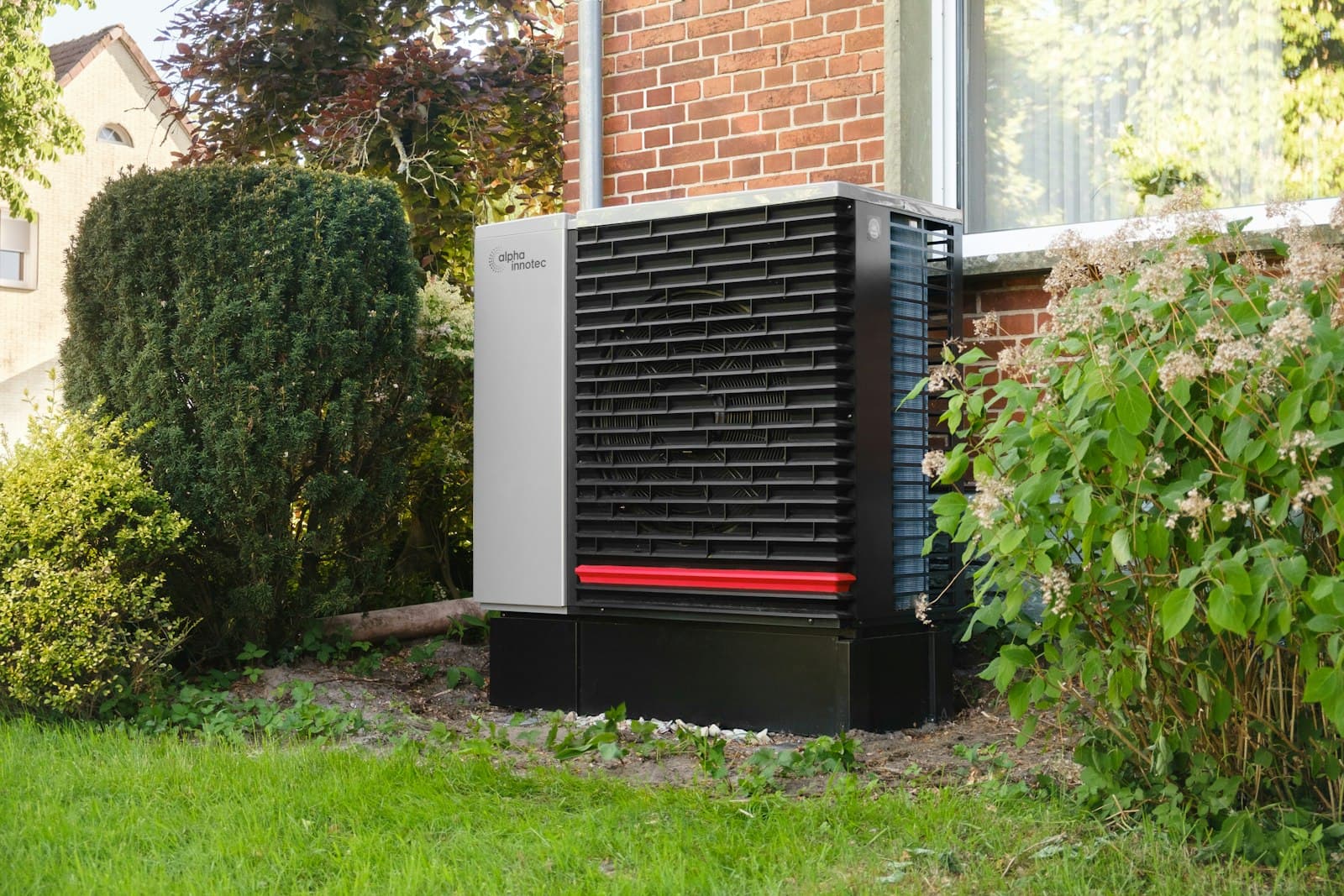 A heat pump outside a brick building